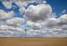 USA, Washington State. Highway 26 just west of Washtucna with clouds over wheat fields and windmill Art Print